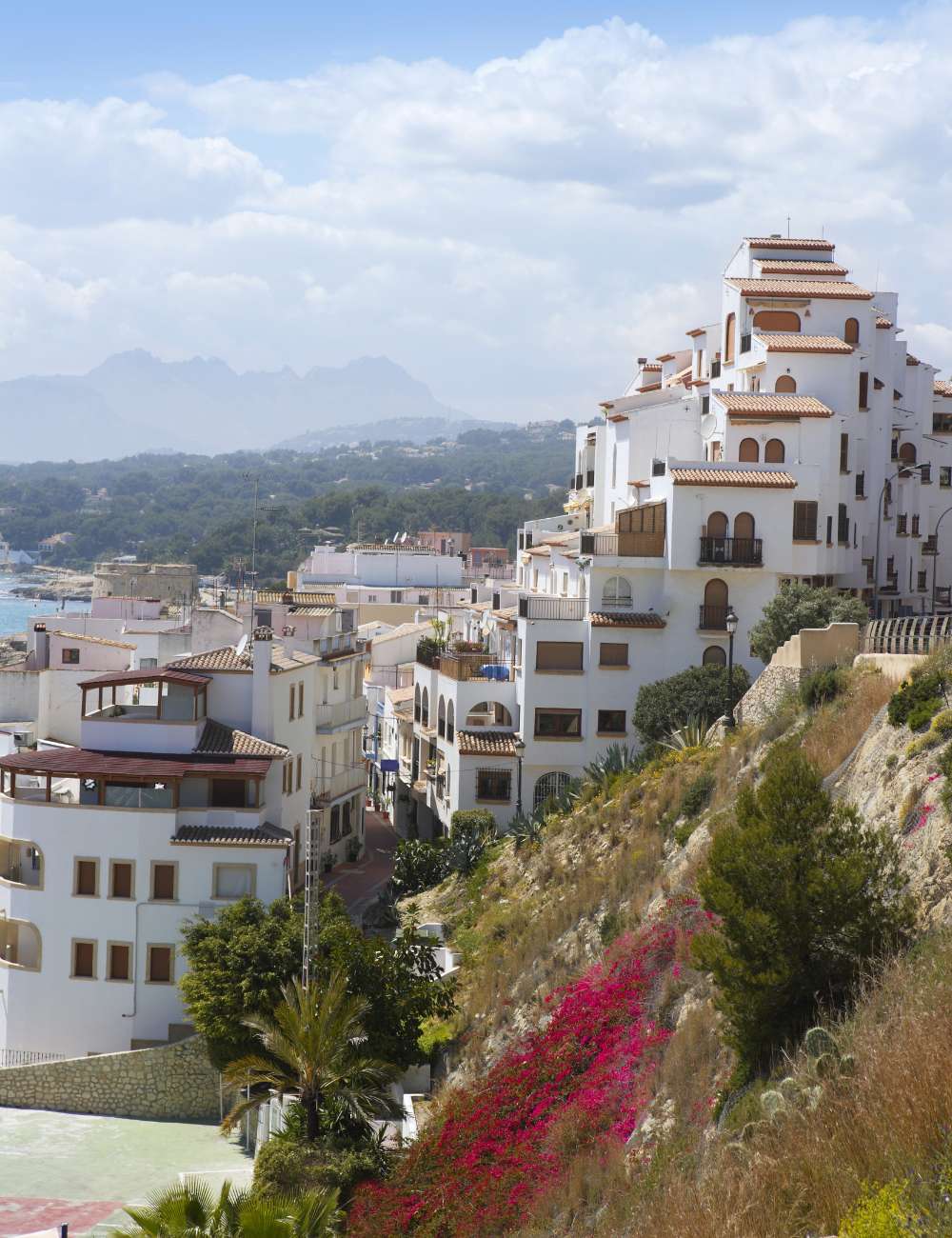 White hillside buildings in central Moraira with mountain backdrop