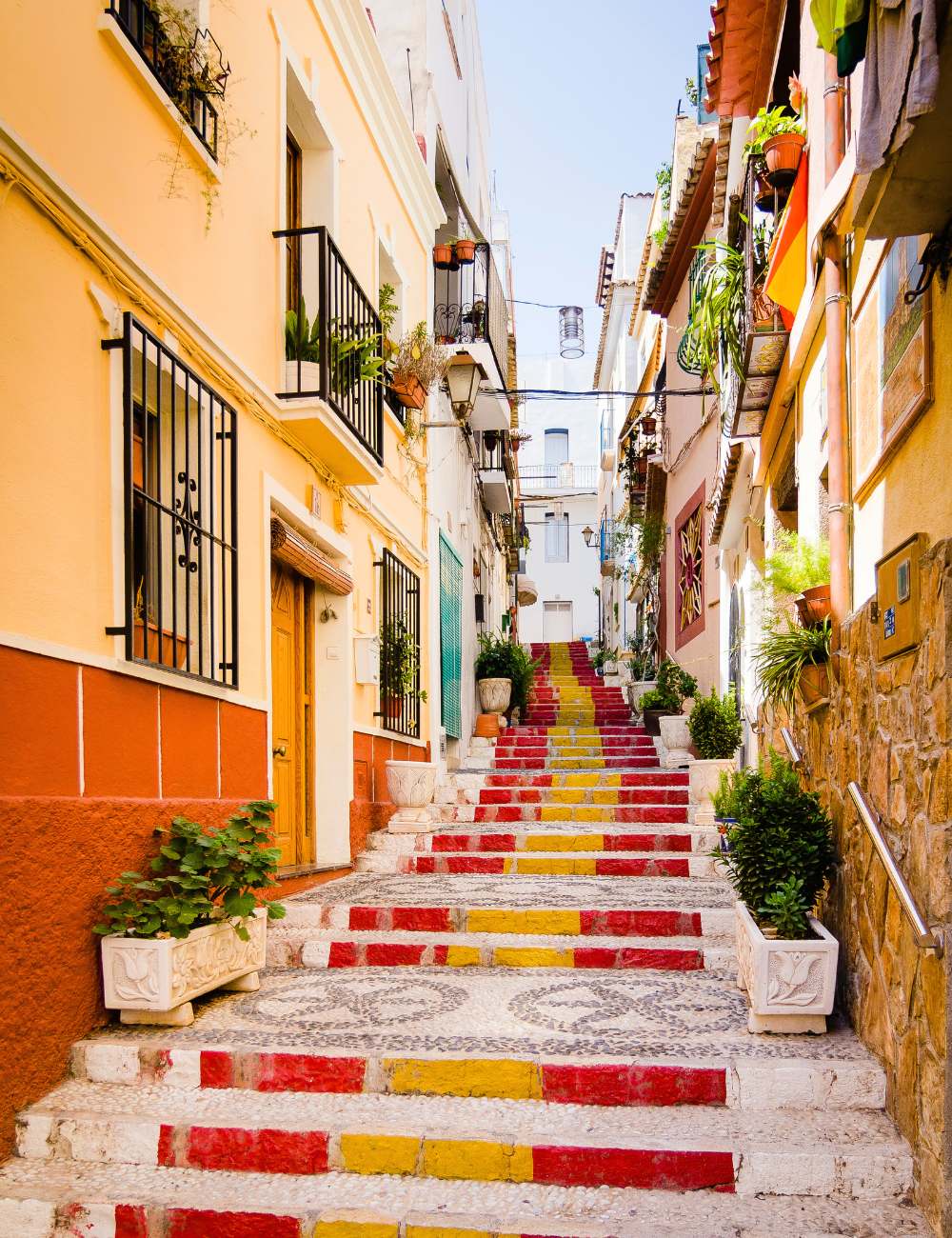 Painted staircase in Calpe’s old town with colourful buildings on either side